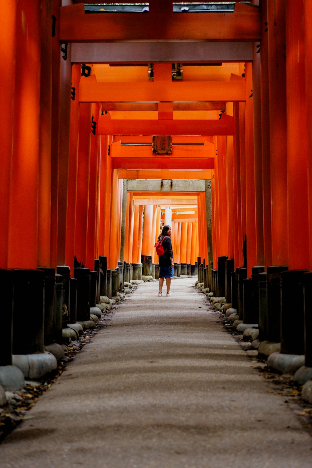 woman under red and black shrine