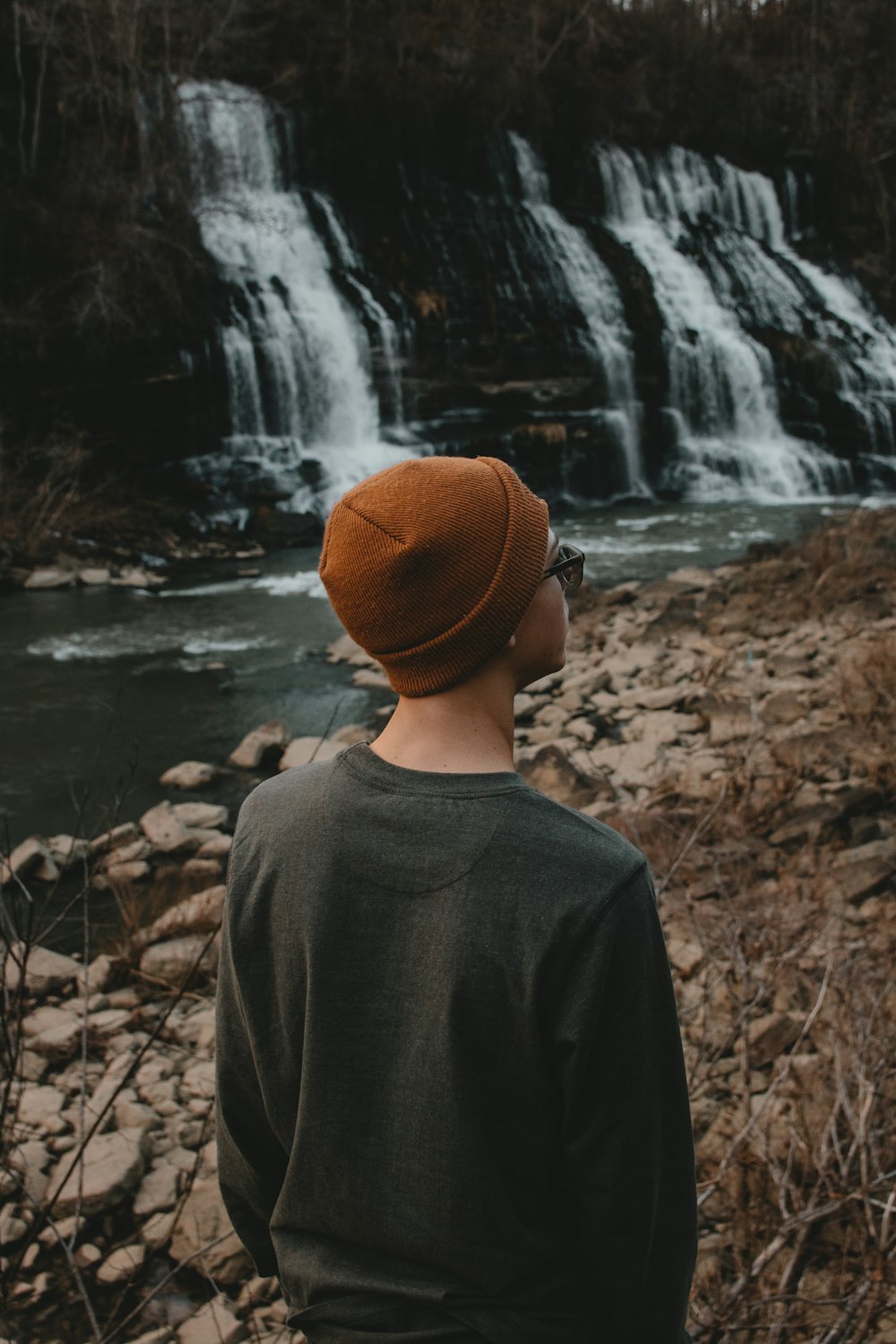 person standing in front of water falls