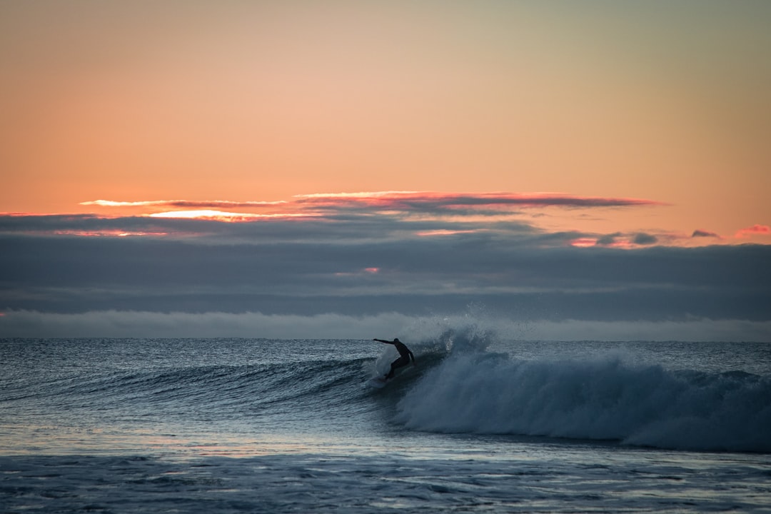 man surfing with giant waves