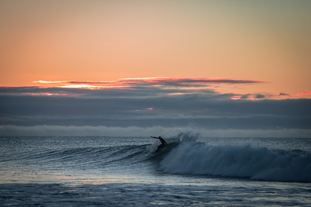 man surfing with giant waves