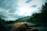 A scenic view of a car driving through the picturesque mountains of North India.