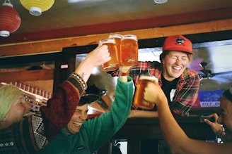 people cheering while holding mugs