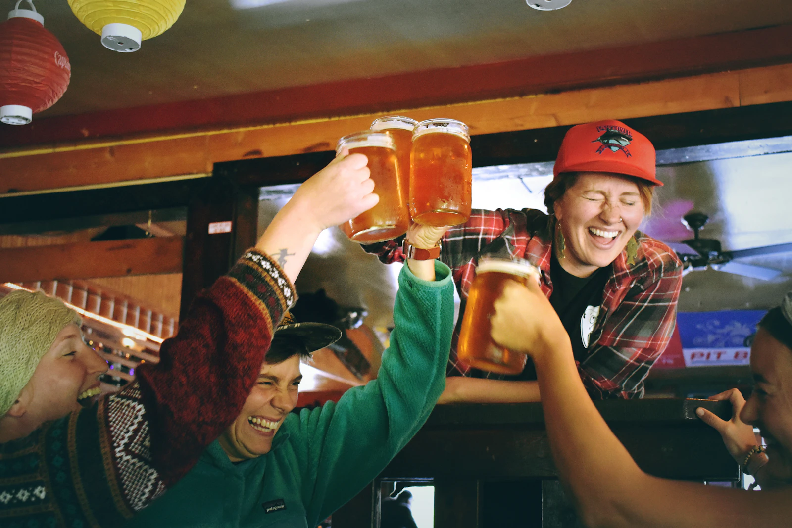People raising beer glasses in the taproom
