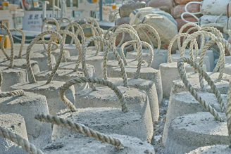 3D printed anchor plates laid out on a training mat with ropes attached