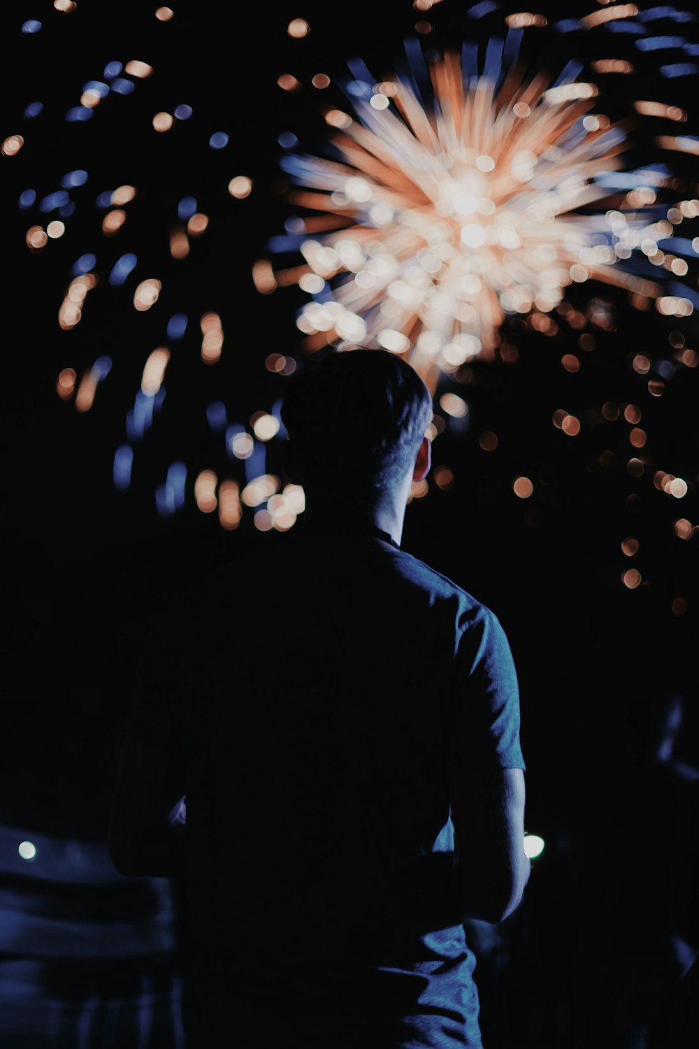 man looking at the fireworks