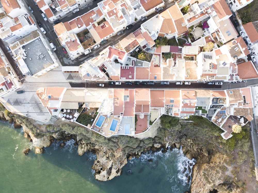 aerial photo of village beside body of water