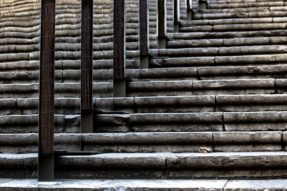 gray concrete stairs with pillars at daytime