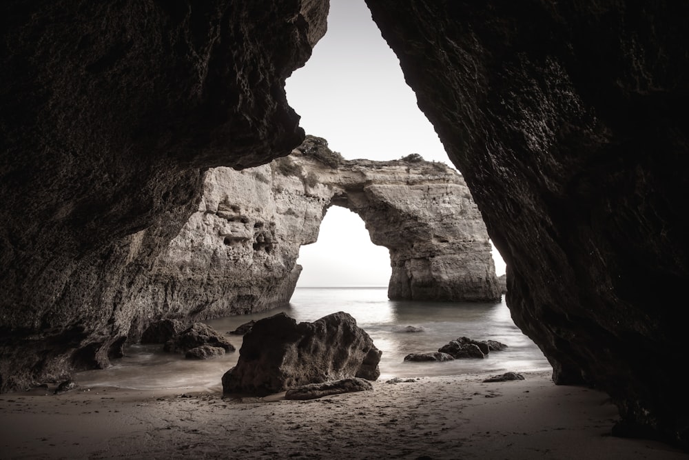 concrete rock formation near body of water