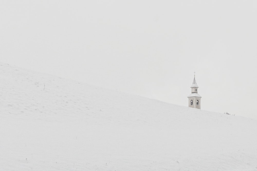 grauer Betonturm auf Schneehaufen