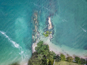 Aerial view of turquoise Caribbean waters and rugged coastline filmed by a professional drone.