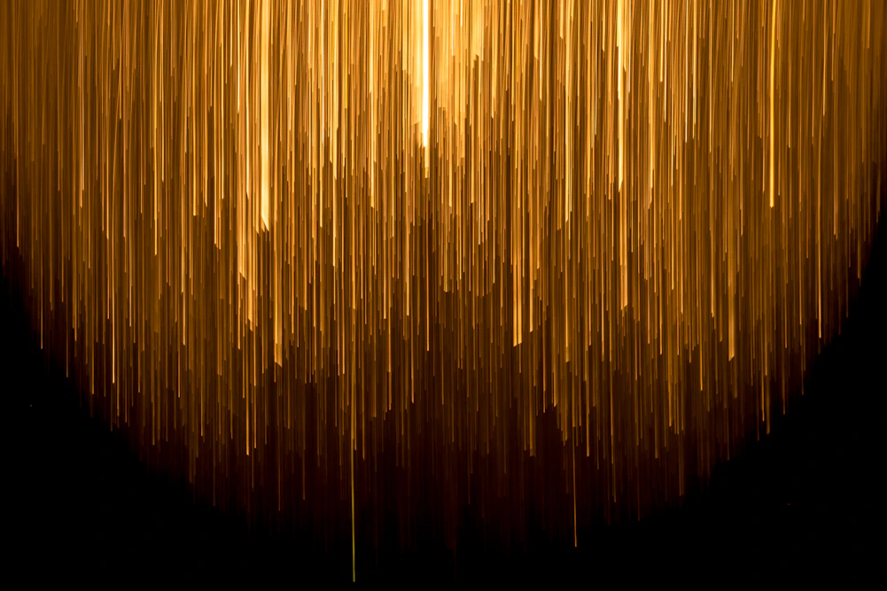 a very long line of yellow lines on a black background
