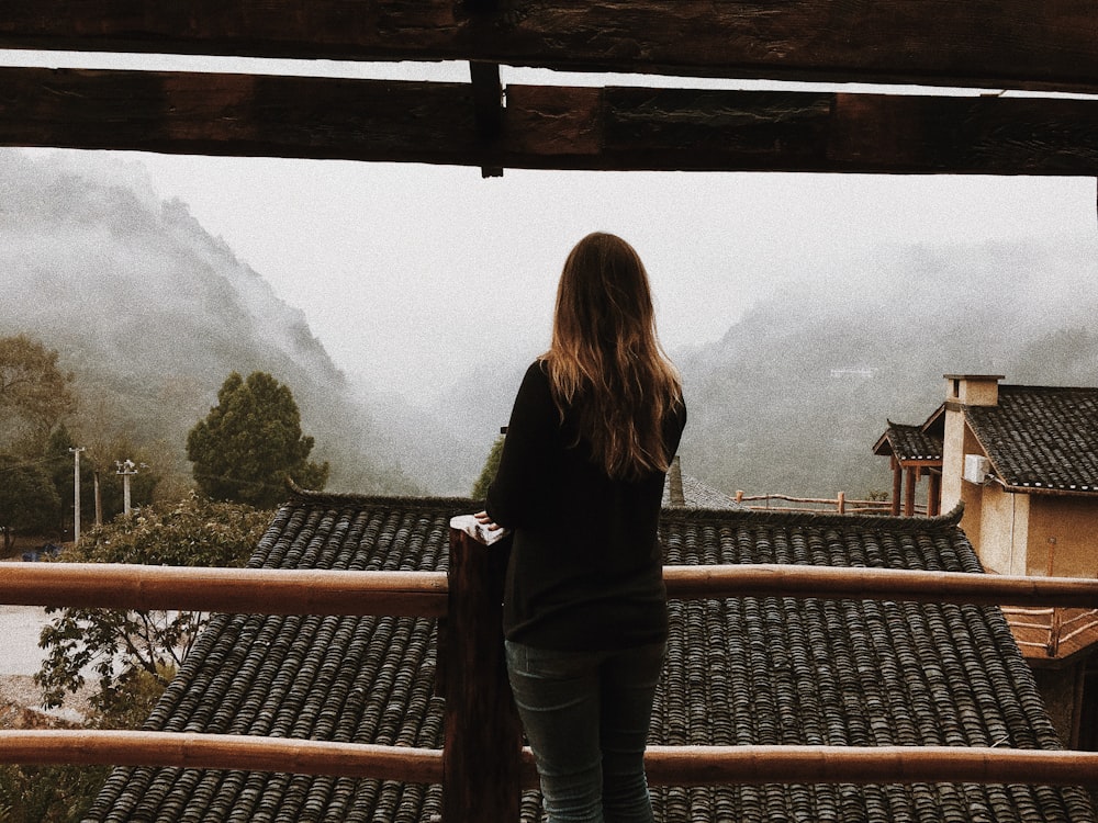 woman standing in front of handrail