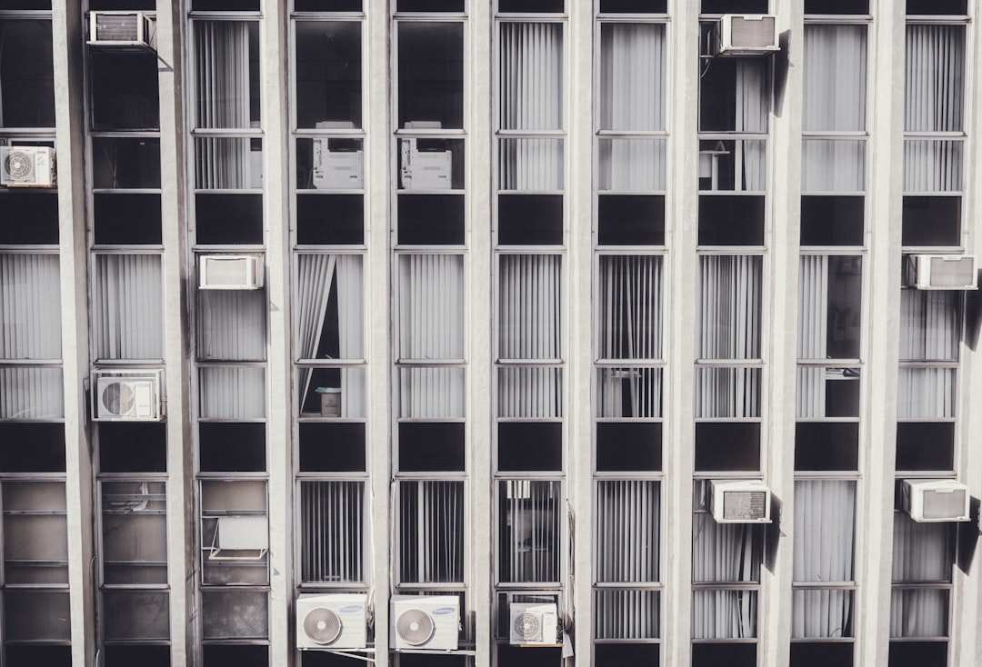 gray high-rise building, behind windows