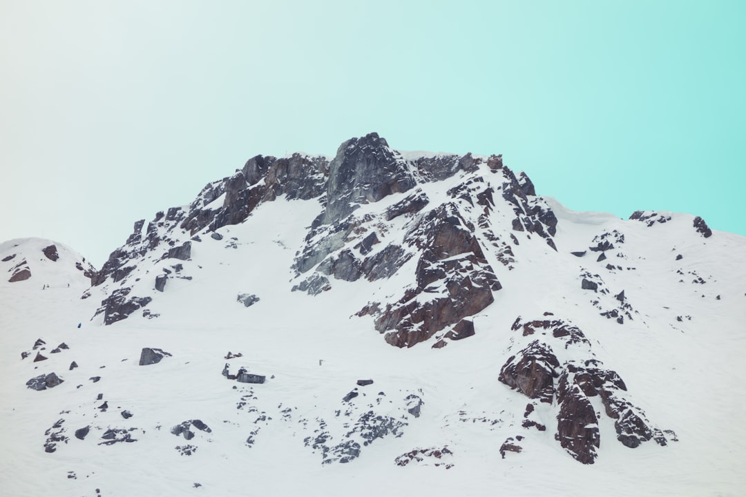 black mountain covered in snow,