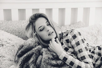 A cozy scene with a model wearing a comfortable cotton lingerie set, surrounded by soft pillows.