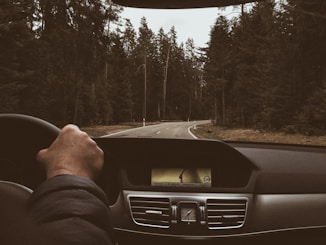 man driving on road