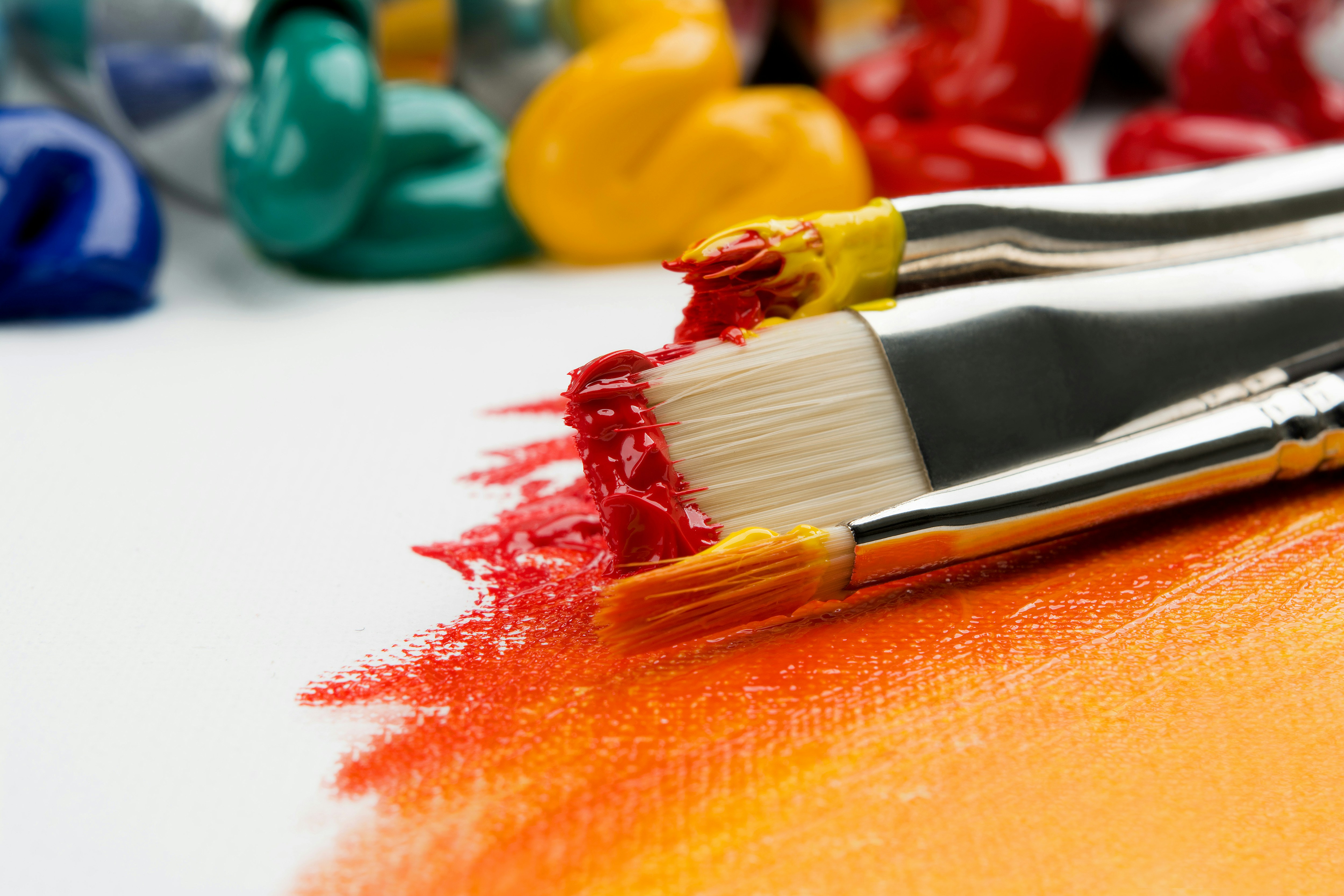 An artist painting with vibrant colors representing the creative expression, community connection, and cultural enrichment that a well-supported arts council fosters through grants, programs, public art, arts education, and community events for every artist and community member in the region it serves