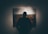 silhouette of man standing in front of painting hanged on wall