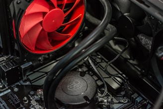 A cooling fan being installed in a desktop case.