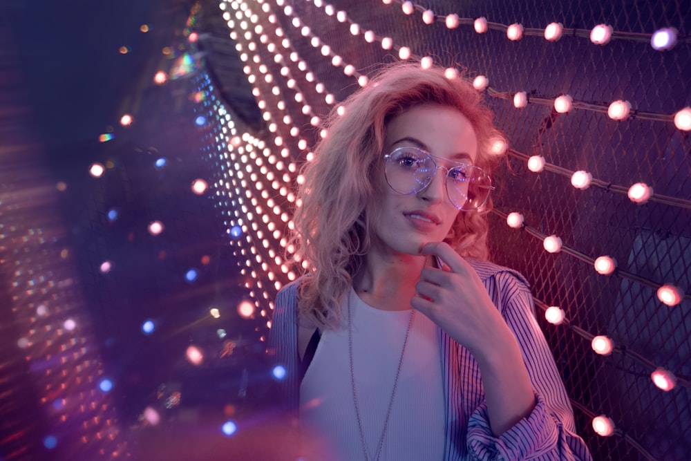 woman standing near string lights