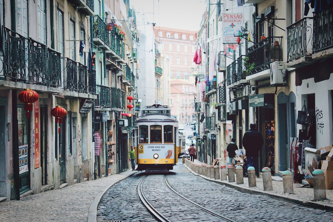 train passing in between buildings in Portugal