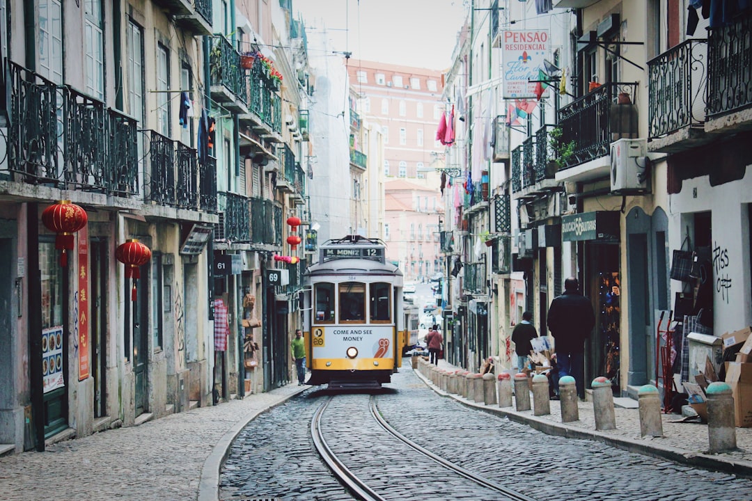train passing in between buildings, come and see money