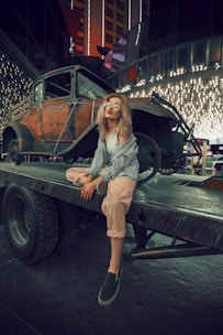 woman sitting on utility trailer during night