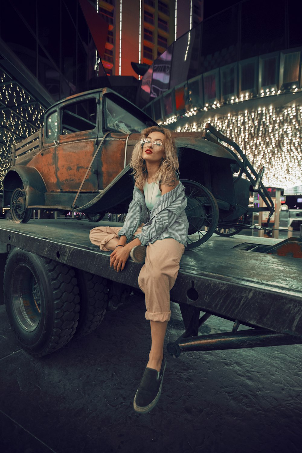 woman sitting on utility trailer during night