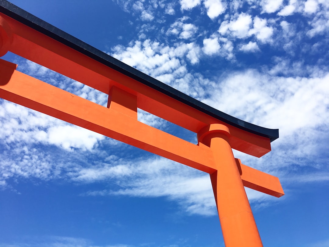 brown wooden frame under blue sky and white clouds during daytime