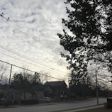 Technicians installing fiber optic cables along a suburban street.