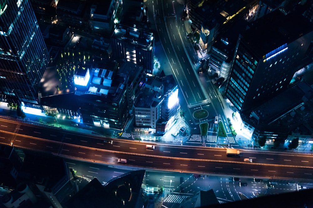 gray road in the middle of buildings during night time