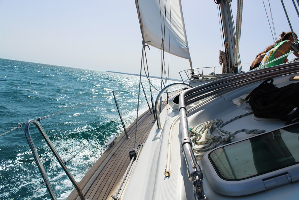 Bateau à moteur blanc incliné sur l’eau pendant la journée