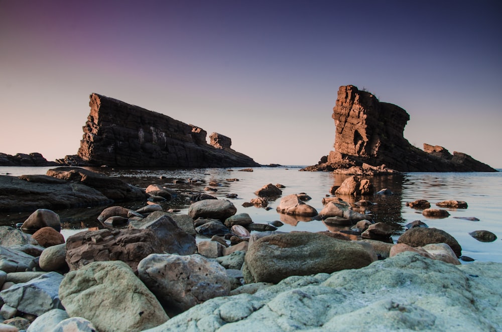 gray stone near body of water