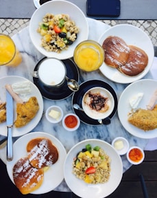 waffles on plate near fried chickens and drinks