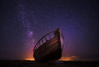 silhouette photography of sailing boat on body of water