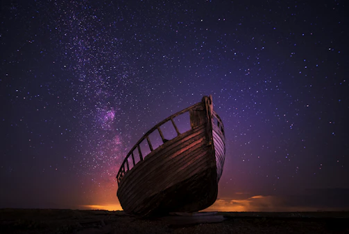 silhouette photography of sailing boat on body of water