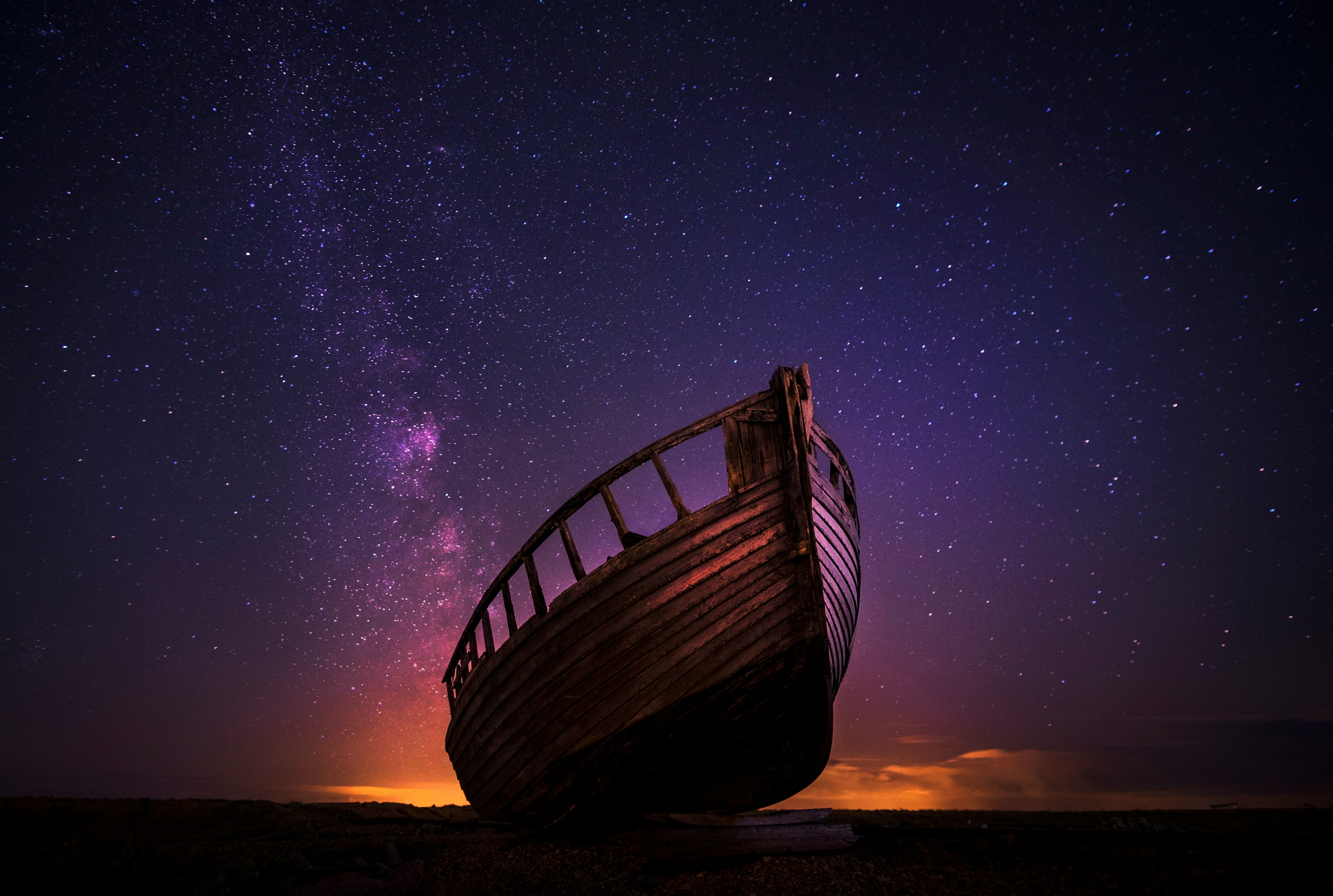 silhouette photography of sailing boat on body of water