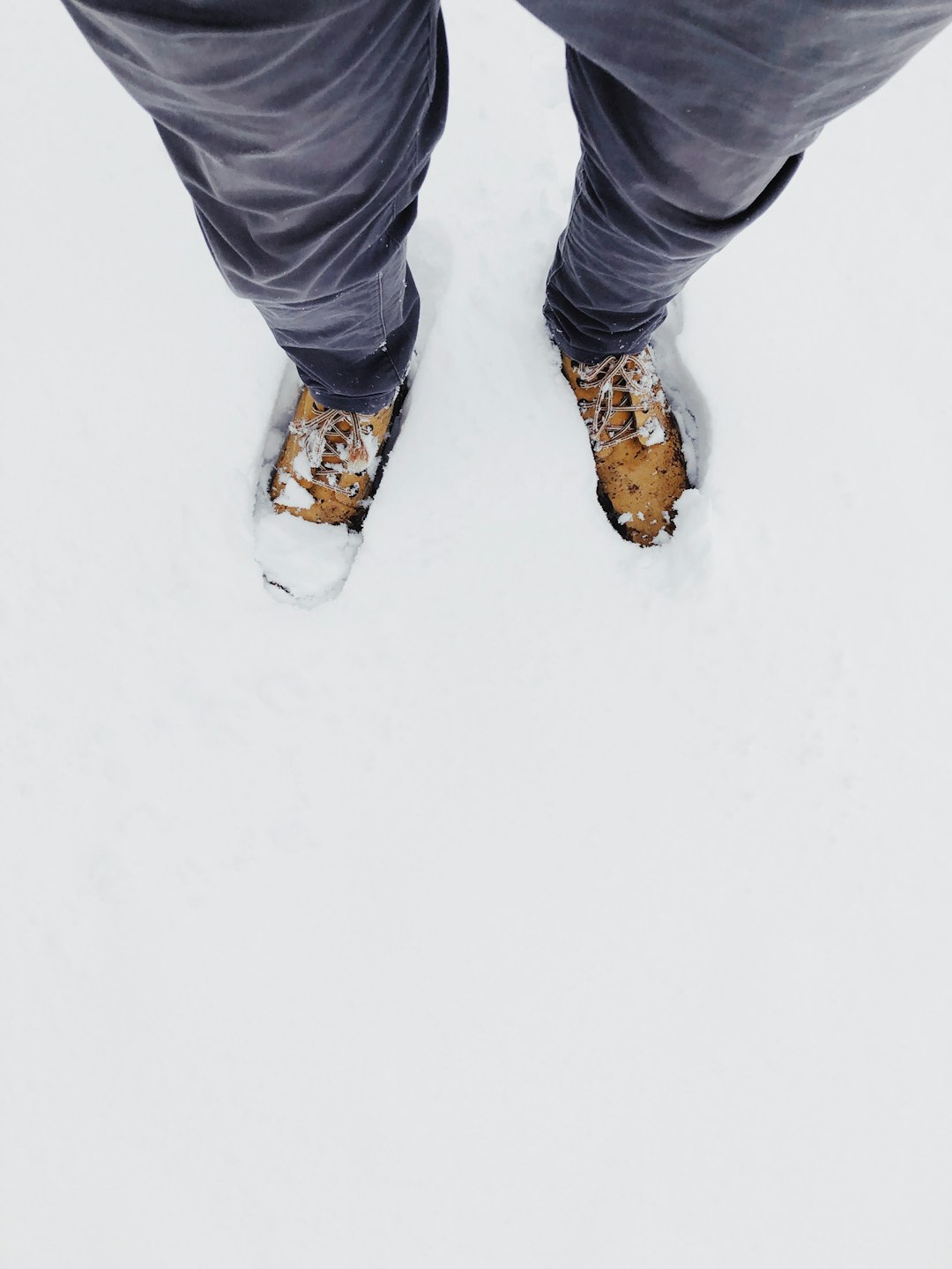 man standing on snow field