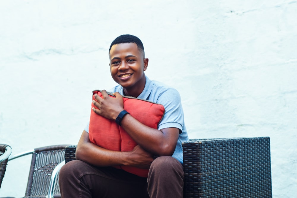 man sitting on sofa near white painted wall