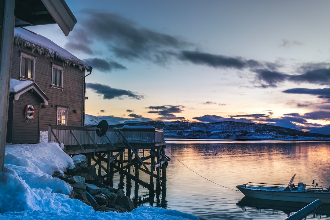 house beside body of water and boat