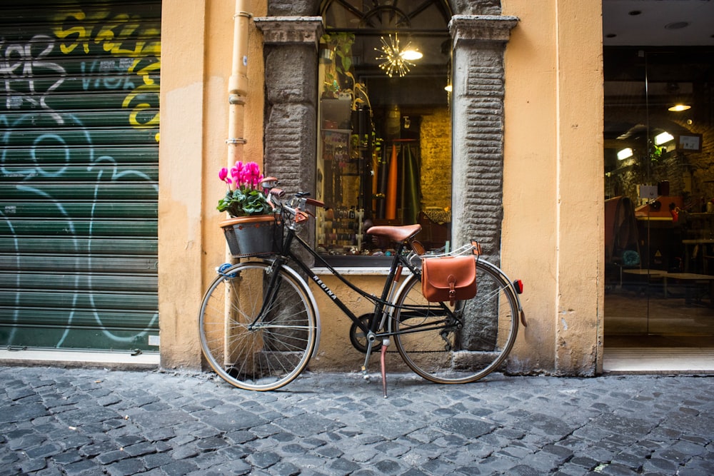 black and brown bicycle parked near window