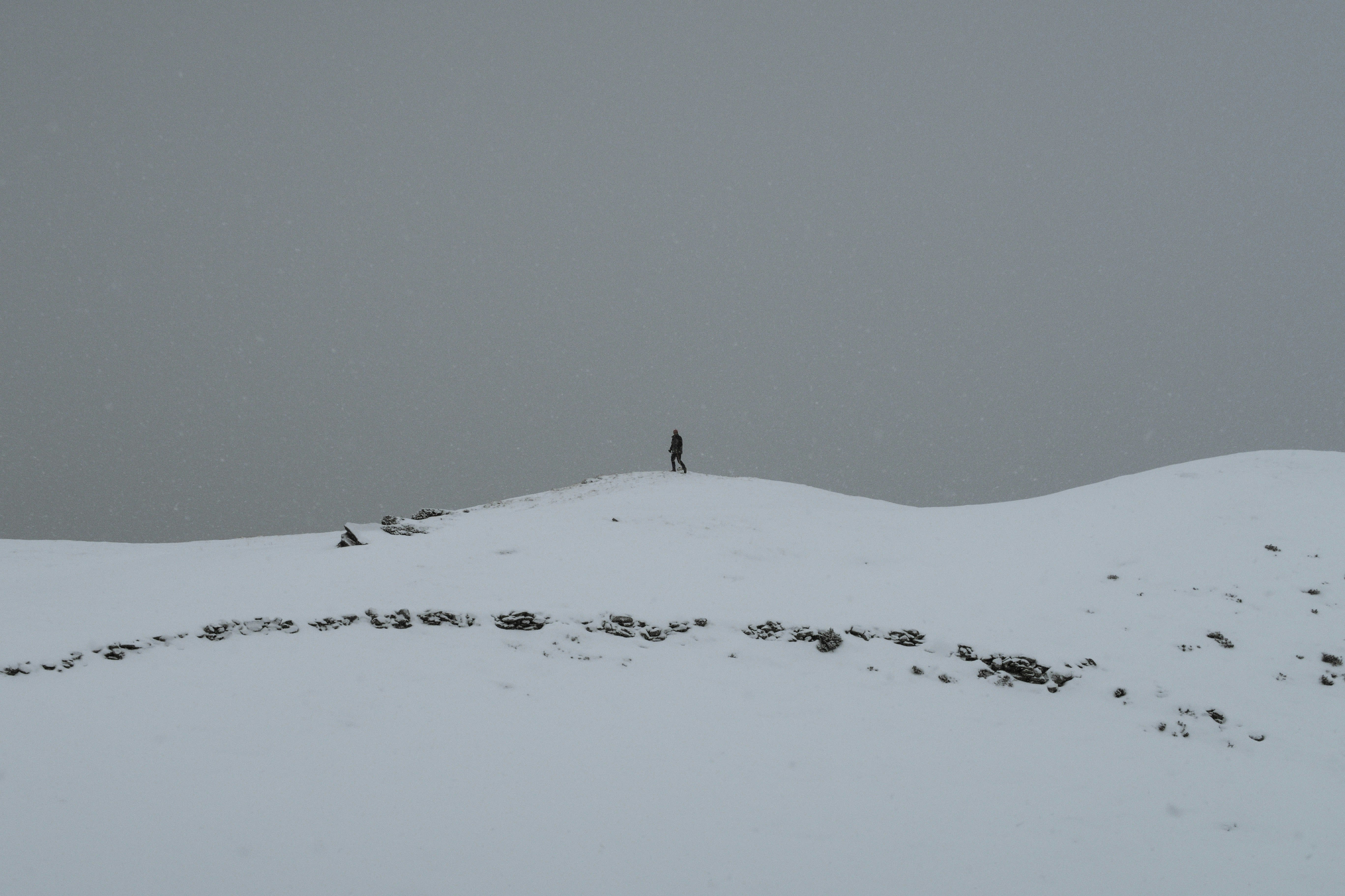 person walking on snow at daytime