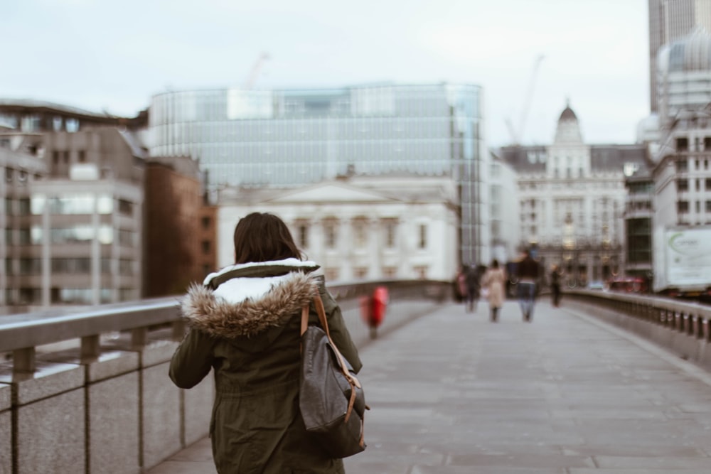 shallow focus photography of woman in green coat