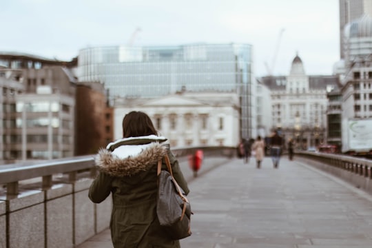 shallow focus photography of woman in green coat in London Bridge United Kingdom