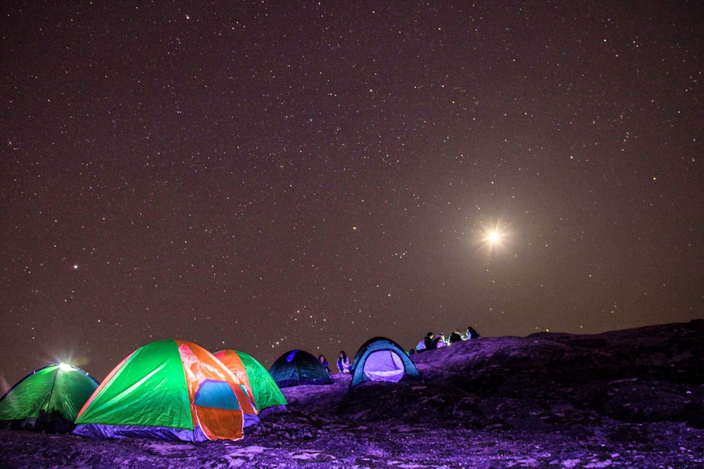 people sitting near tents during nightitme