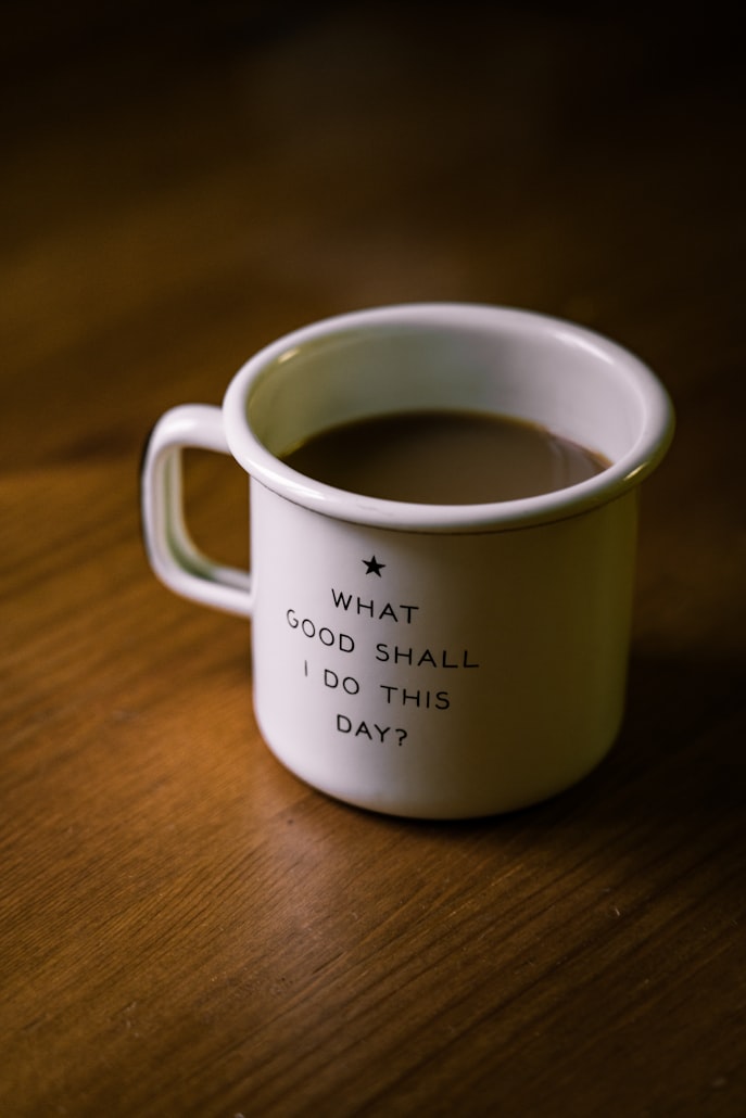 mug of coffee that reads "what good shall I do this day"