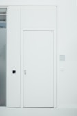 Minimalist white interior door blending seamlessly with a clean, contemporary room.