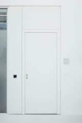 Modern white PVC door installed in a bright, contemporary home interior.