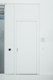 A sleek modern interior door with a smooth white finish and minimalist design.