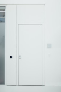 A sleek modern interior door with a smooth white finish and minimalist design.